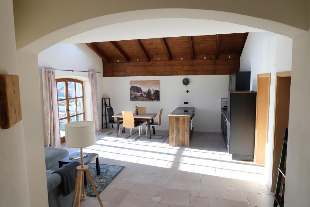 a living room with a kitchen and a table at Ferienwohnung Stöckl in Grabenstätt