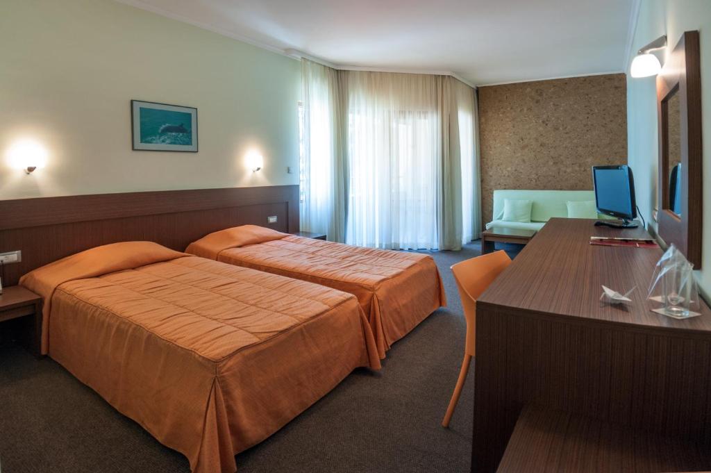 A bed or beds in a room at Jeravi Beach Hotel - All Inclusive