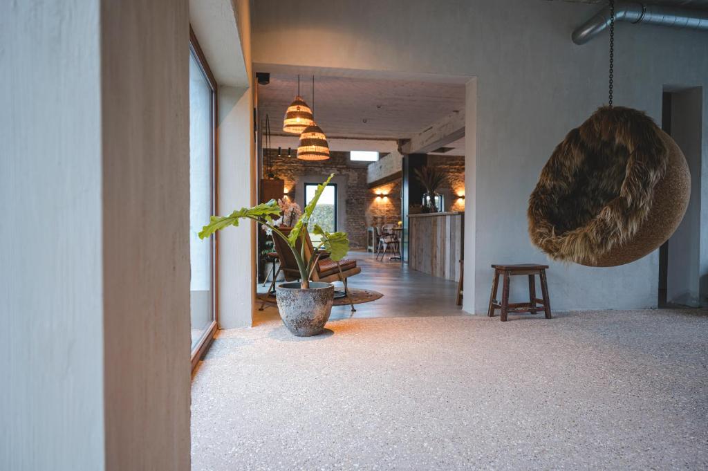 a hallway with a plant in the middle of a building at BBruT in Bruges