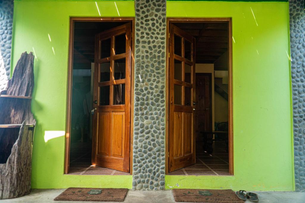 a room with two doors and a green wall at Two houses with a private pool. in Pavones
