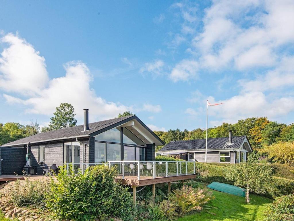 a home with a deck and a house at Holiday home Børkop LVI in Børkop