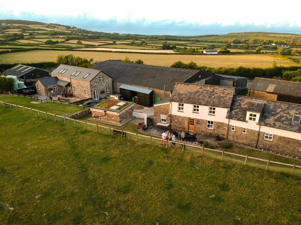 a group of people standing in front of a house at Bunk House - 4 Bedroom - Llangenith in Llangennith