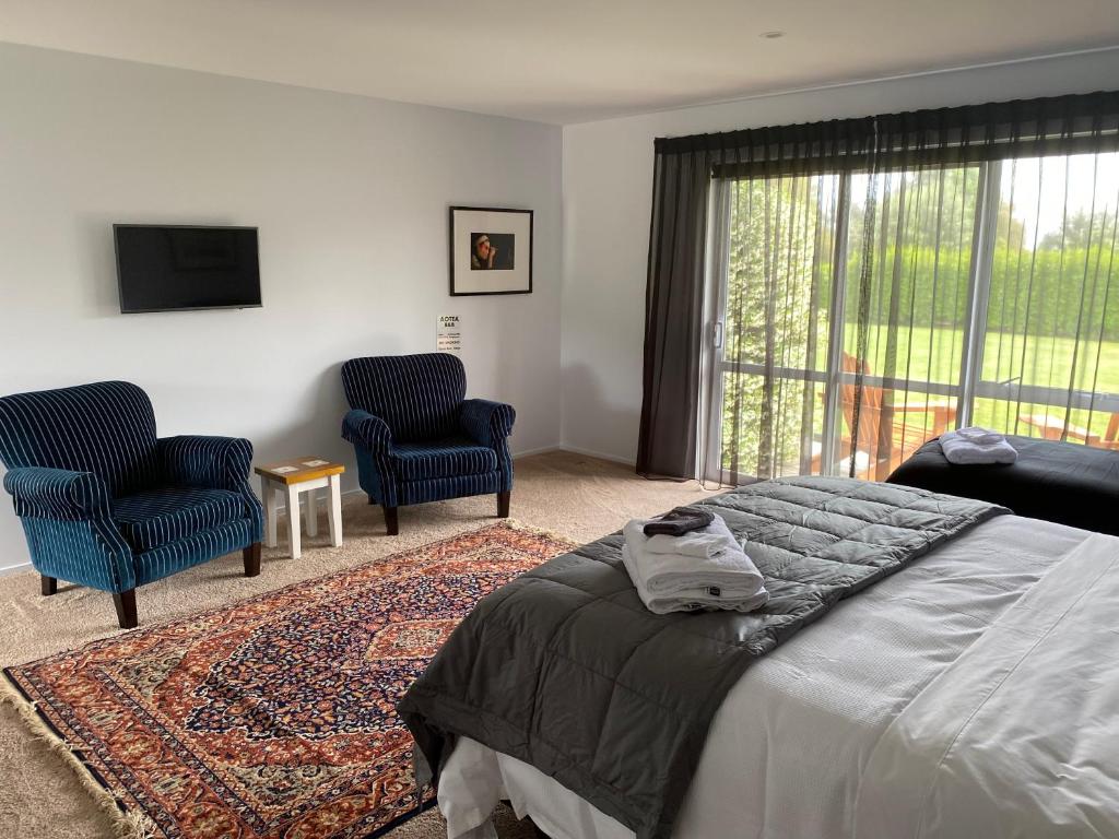 Postel nebo postele na pokoji v ubytování Fitzroy BnB 39b Whangapoua Road