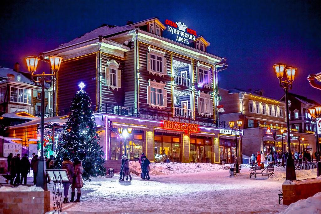 a christmas tree in front of a building at Kupechesky Dvor in Irkutsk