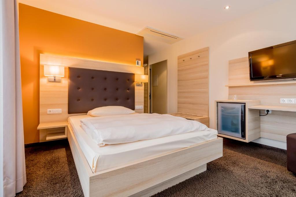 Postel nebo postele na pokoji v ubytování Hotel Bacchus