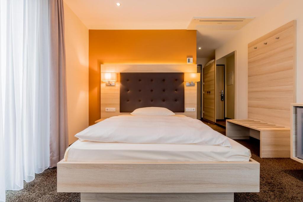 Postel nebo postele na pokoji v ubytování Hotel Bacchus