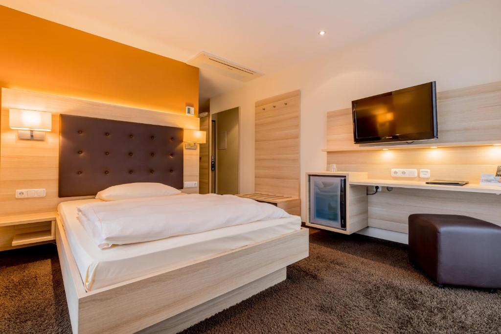 Postel nebo postele na pokoji v ubytování Hotel Bacchus