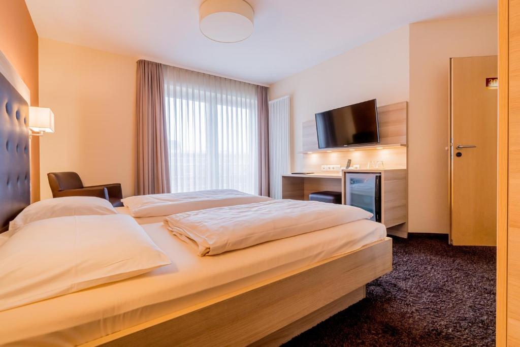Postel nebo postele na pokoji v ubytování Hotel Bacchus