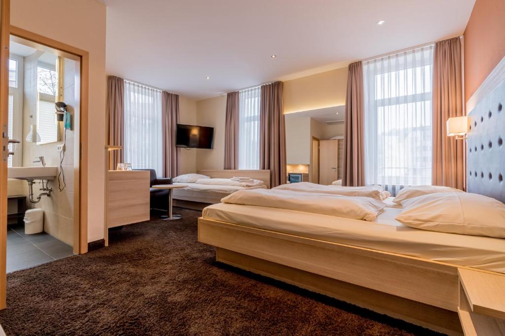Postel nebo postele na pokoji v ubytování Hotel Bacchus