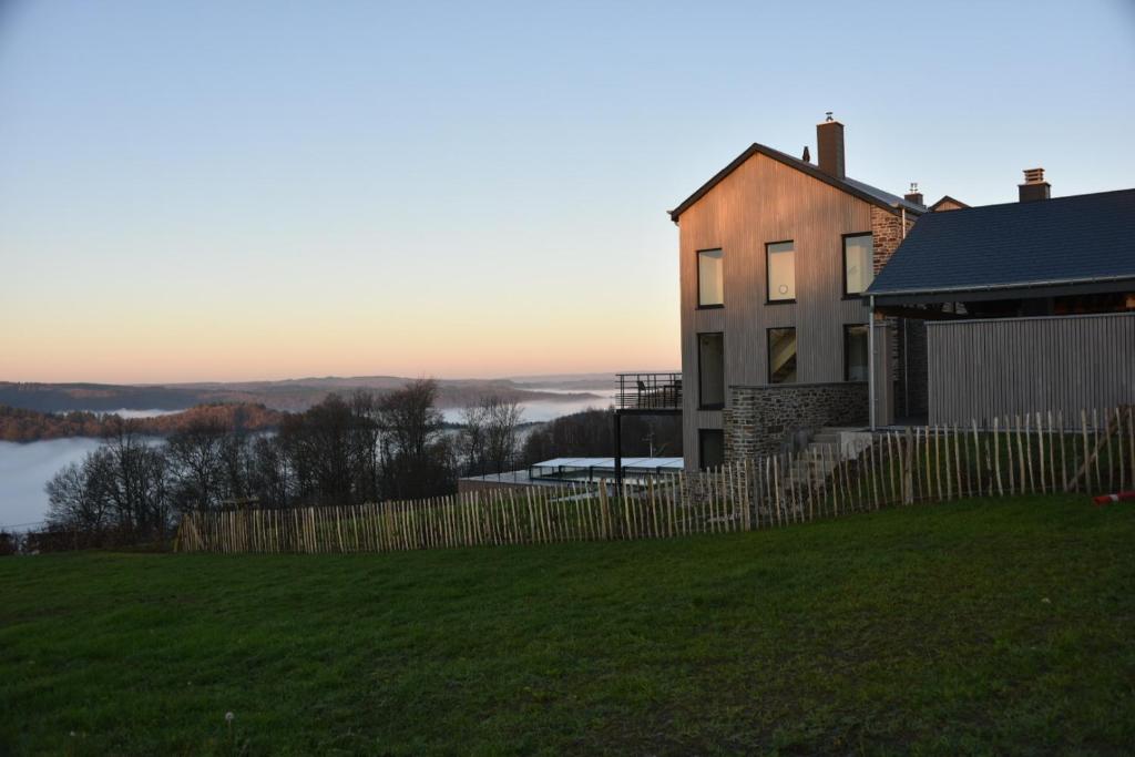 een huis op een heuvel met een hek bij Rochehaut, Les Semoiselles, Villa Isabelle in Bouillon
