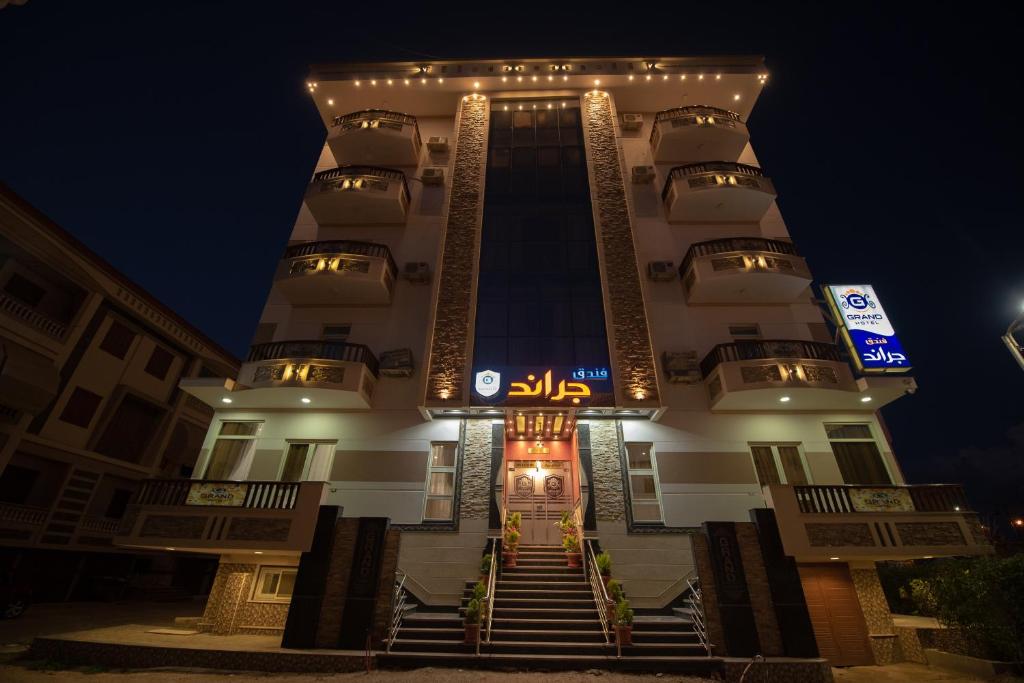 a large building with stairs leading up to it at night at Grand Hotel Ras Elbar in Ras El Bar