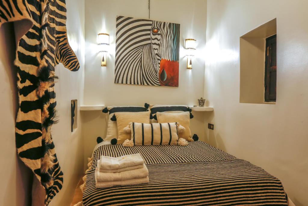 Postel nebo postele na pokoji v ubytování Riad Dada Mouss & Suites