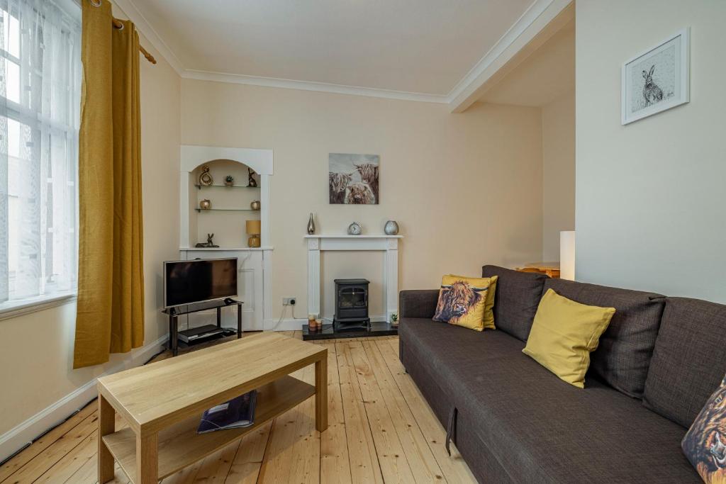 a living room with a couch and a table at Bright flat in Lauder Centre in Lauder