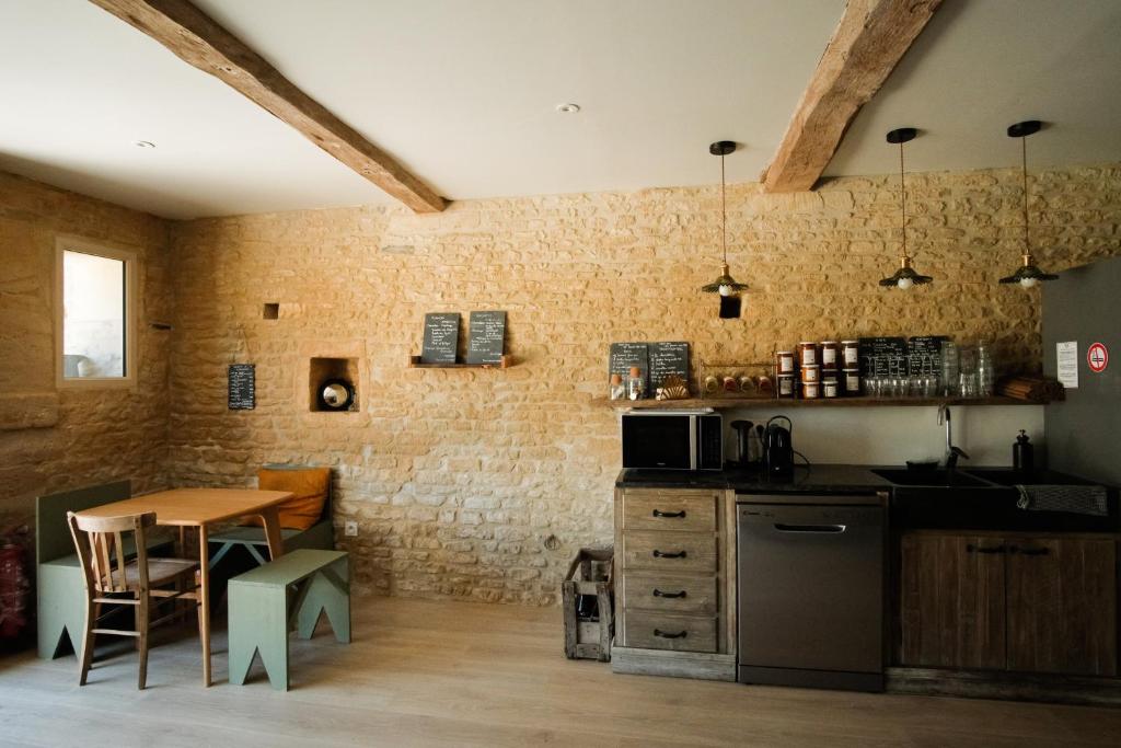 a kitchen with a table and a counter top at Le Domaine de l&#39;Hostellerie in Le Fresne-Camilly