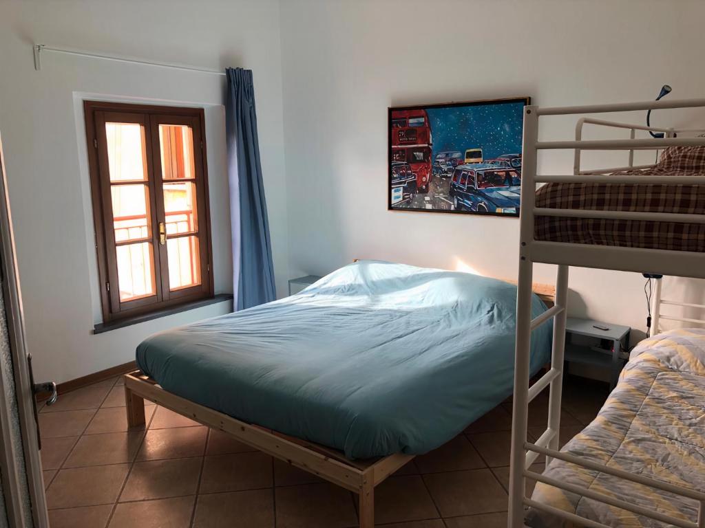 a bedroom with a bunk bed and a window at Camera San Jacopo in Altopascio