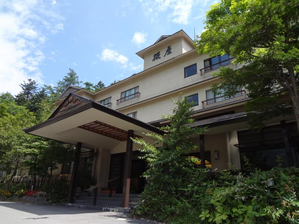 a large white building with a roof at Yumoto Itaya in Nikko