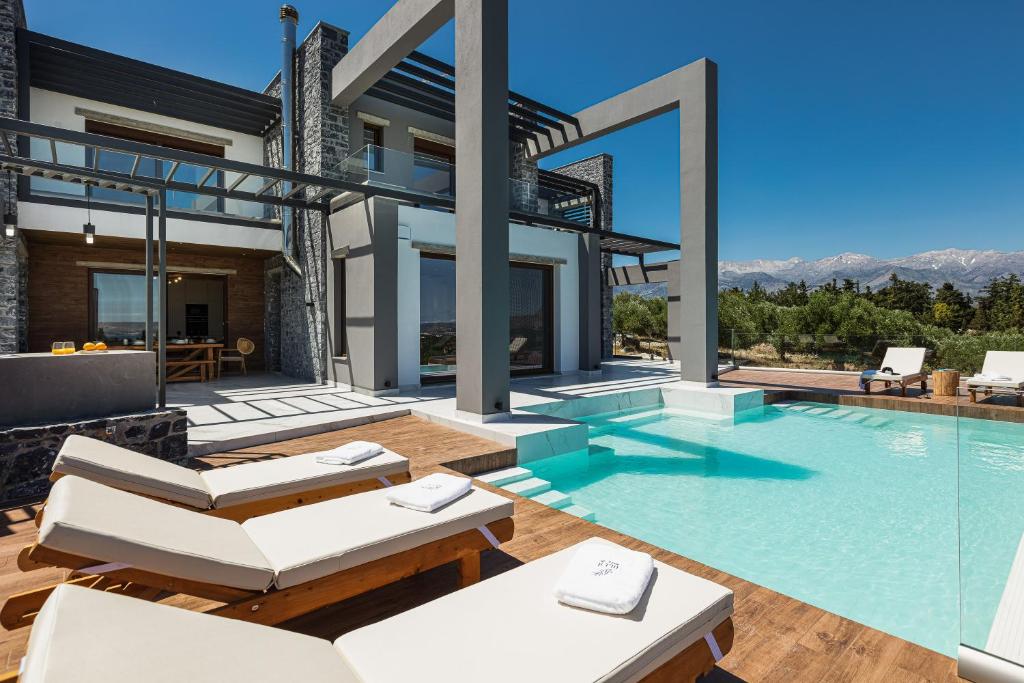 a villa with a swimming pool and a patio at Eloa Luxury Villa in Chania Town