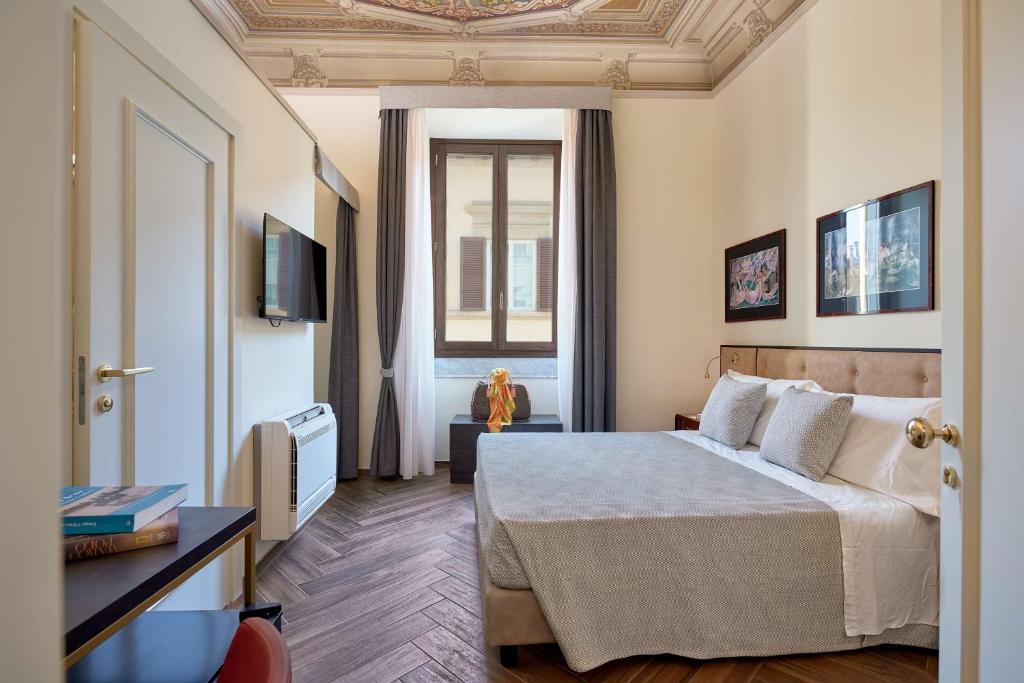 a hotel room with a bed and a window at Residenza Mondragone in Florence