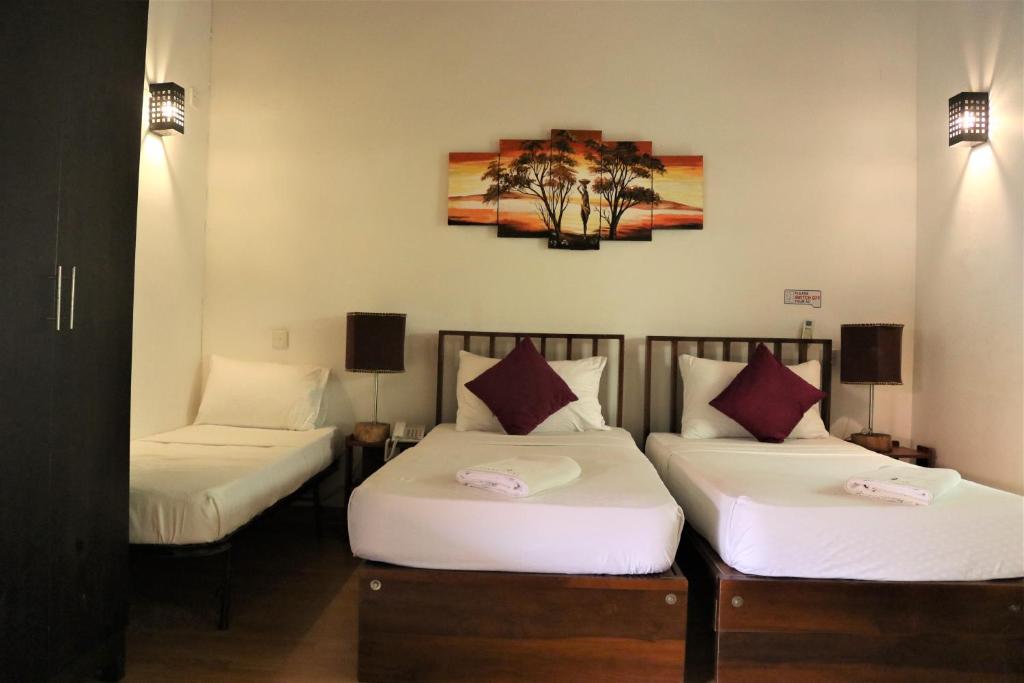 Postel nebo postele na pokoji v ubytování Pavana Hotel