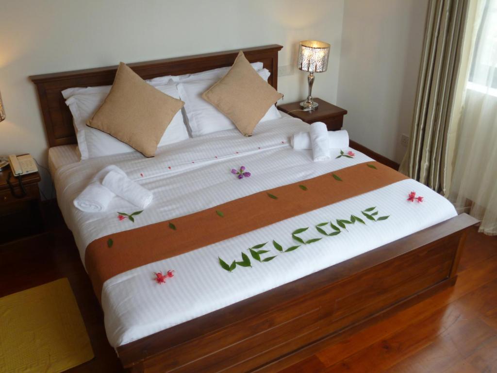 Postel nebo postele na pokoji v ubytování Daffodil's Hotel