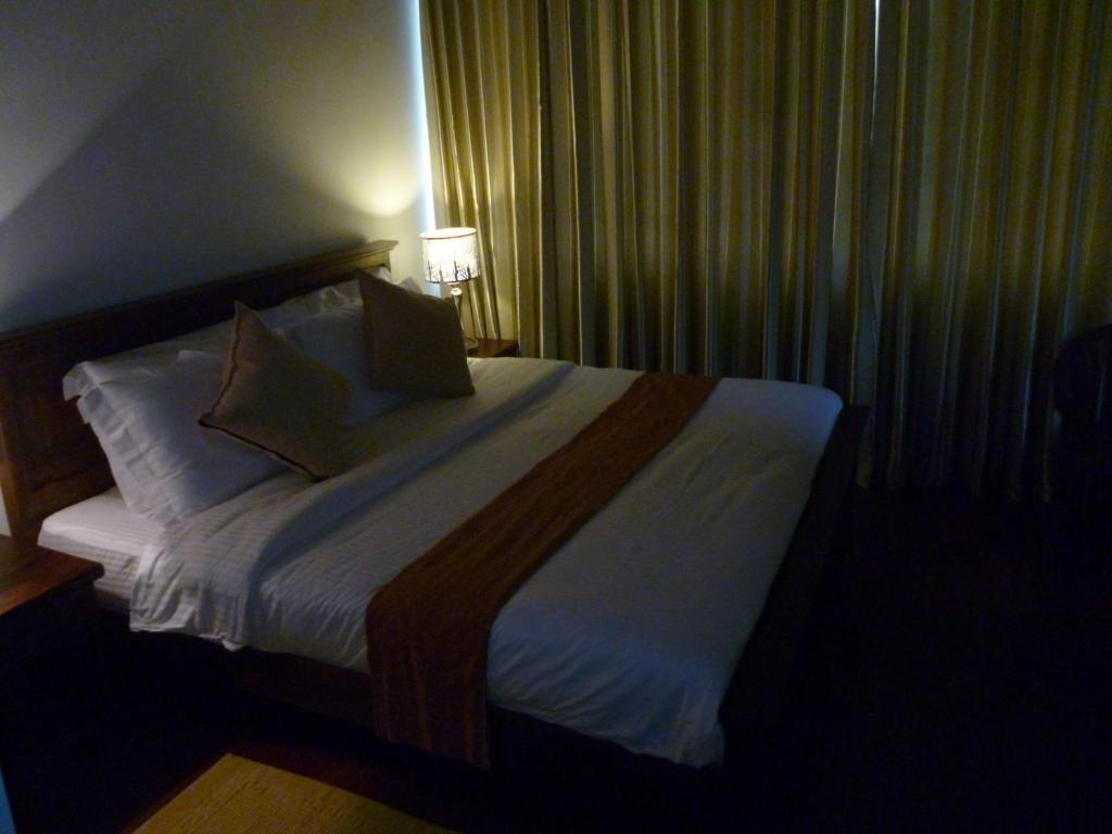 Postel nebo postele na pokoji v ubytování Daffodil's Hotel