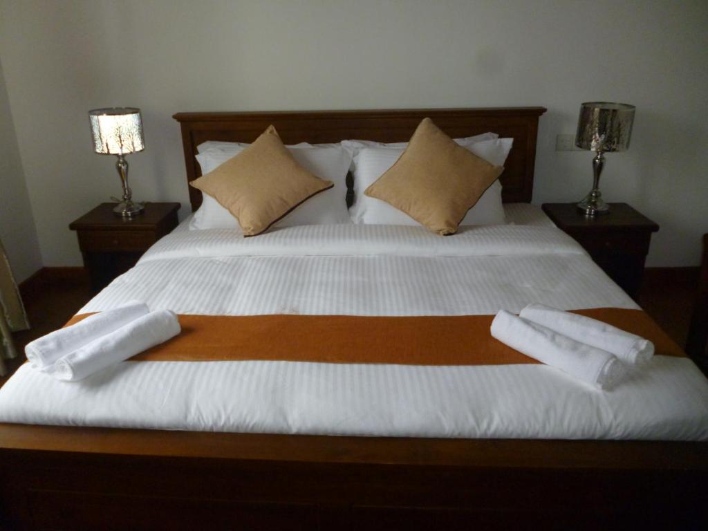 Postel nebo postele na pokoji v ubytování Daffodil's Hotel