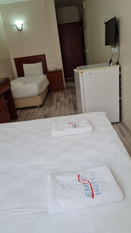 a bedroom with two white towels on a bed at EMOS HOTEL in Istanbul