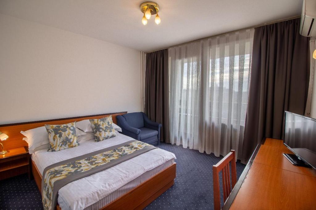 Postel nebo postele na pokoji v ubytování Hotel Novi Zagreb