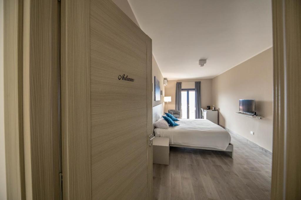 a bedroom with a bed and a door leading into a room at Il Gelso Guest House in Catanzaro