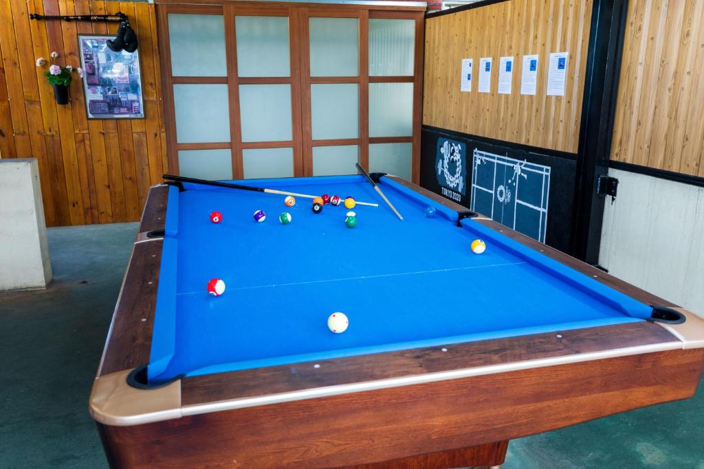 a blue pool table with balls on it at Hostel Alley Inn -桃園民宿075 in Daxi
