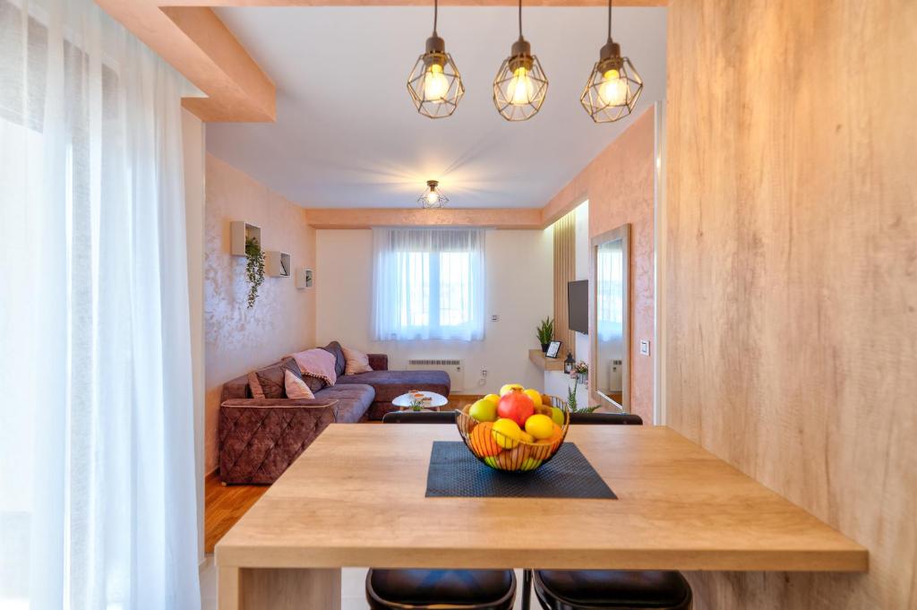 uma cozinha com uma mesa com uma taça de fruta em Apartment Stefan in Vila Katalina Lux em Zlatibor