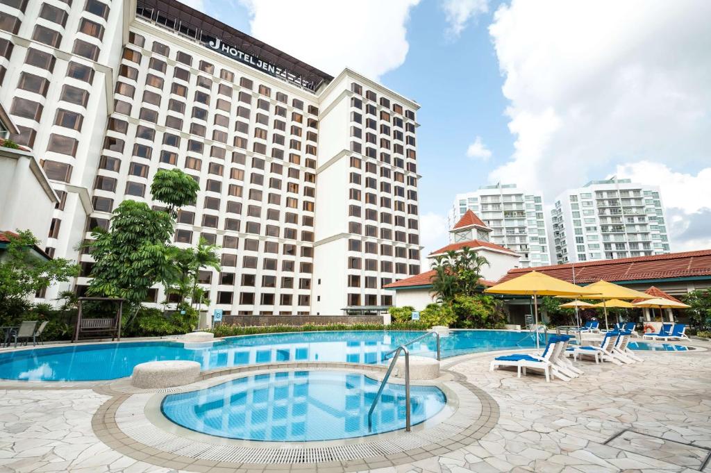 シンガポールにあるJEN Singapore Tanglin by Shangri-Laの建物の前にスイミングプールがあるホテル