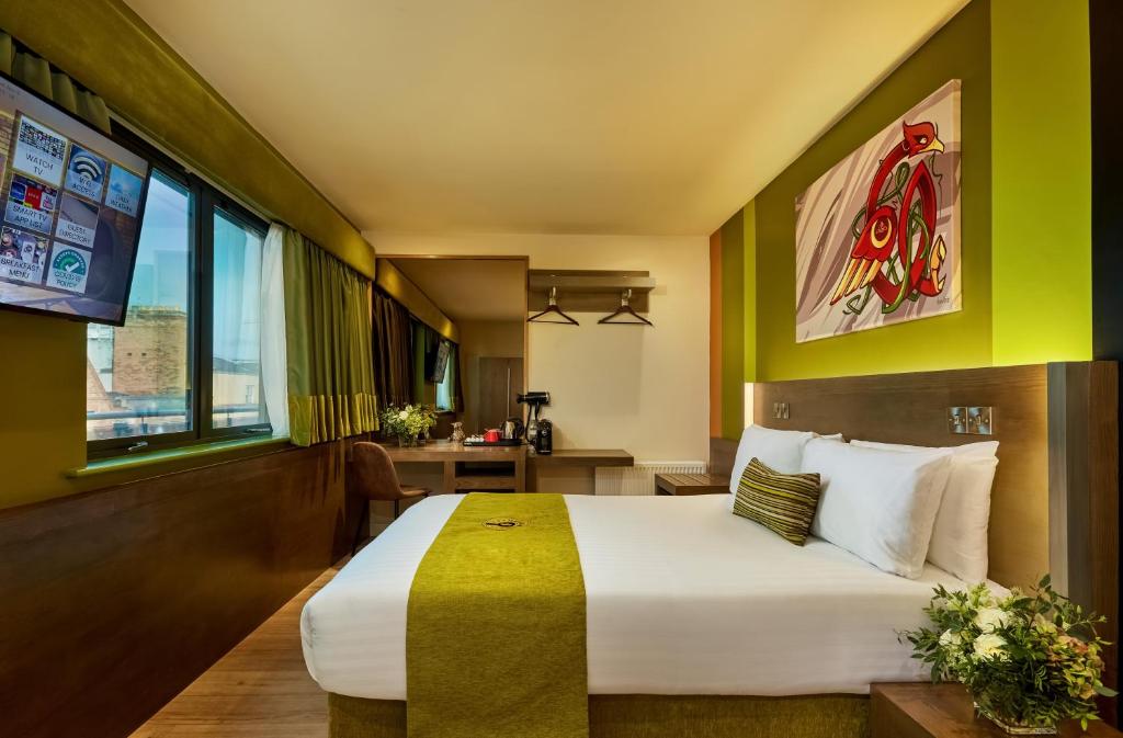 a hotel room with a bed and a desk at Temple Bar Inn in Dublin