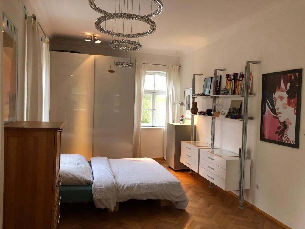 a bedroom with a bed and a chandelier at Haus mit Geschichte in Mähring in Mähring
