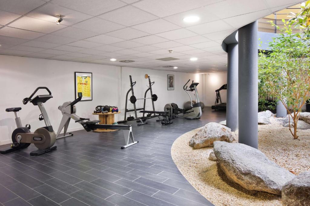 a gym with treadmills ellipticals and exercise bikes at Sure Hotel by Best Western Nantes Beaujoire in Nantes