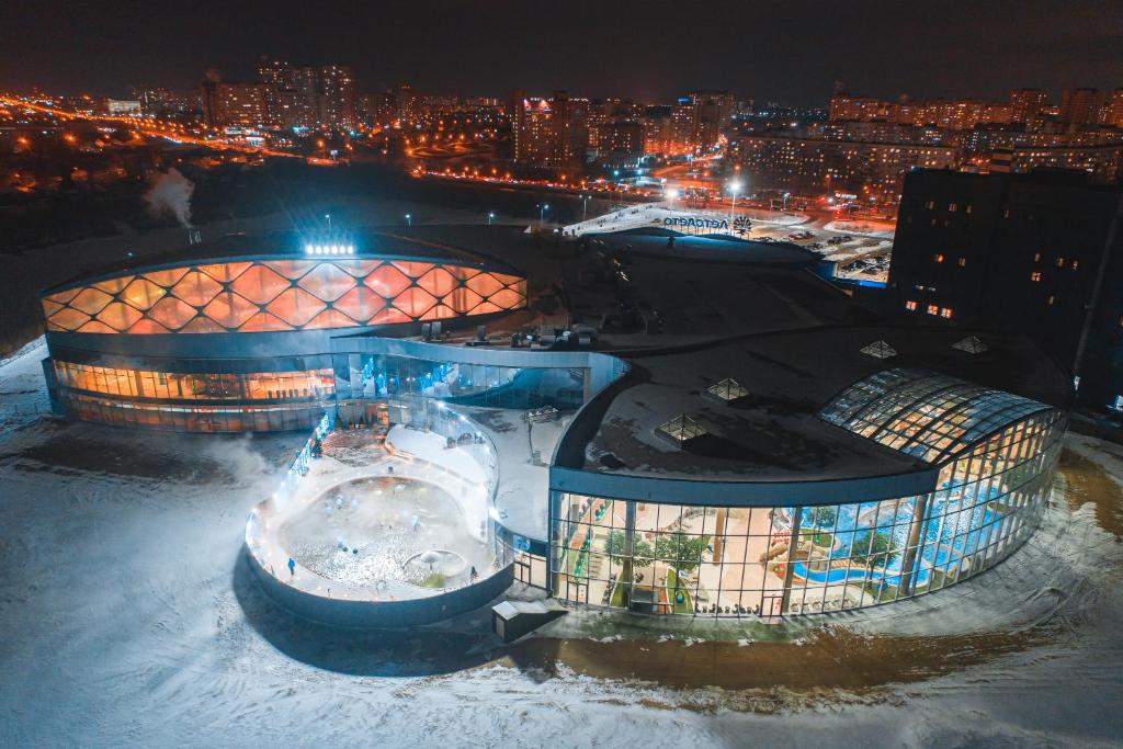 a building in the snow with a city at night at Марциаль in Tyumen