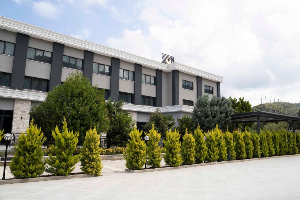 an office building with trees in front of it at Vela Verde Hotel & SPA Yalova in Yalova