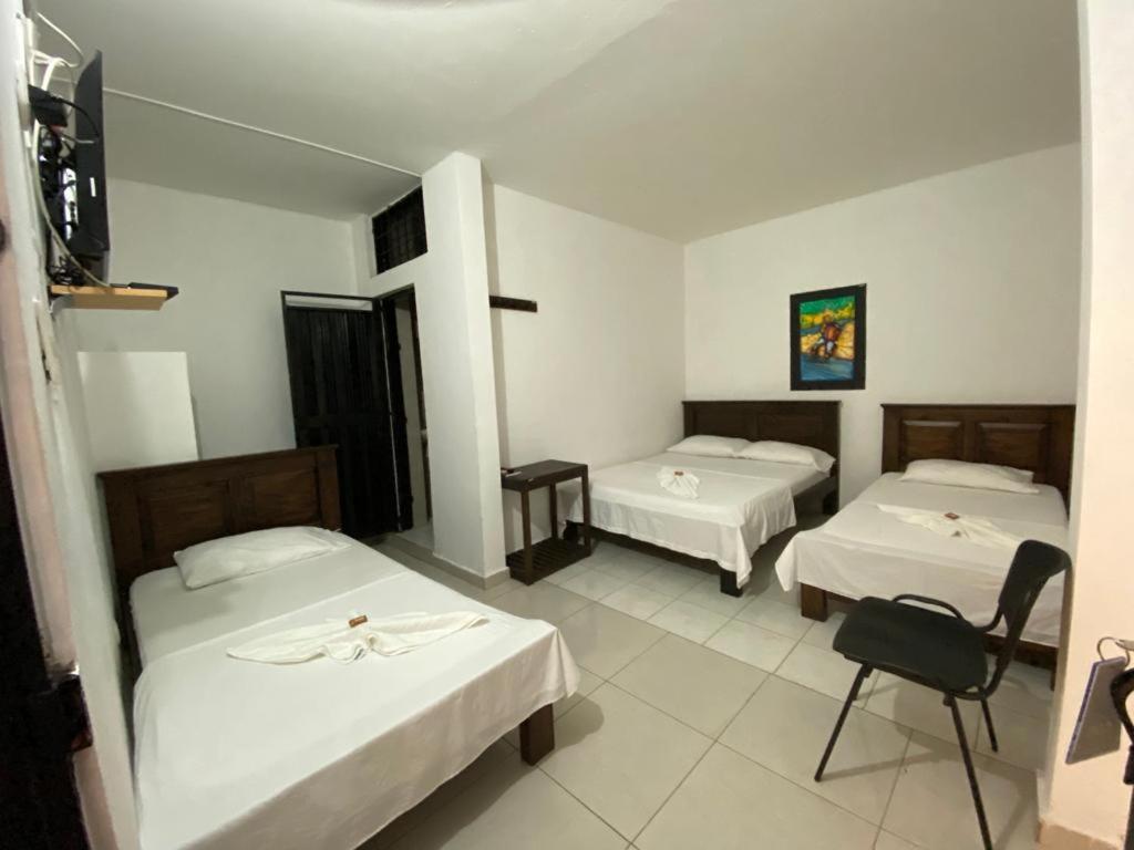 Ліжко або ліжка в номері Aparta Hotel El Cacique Upar
