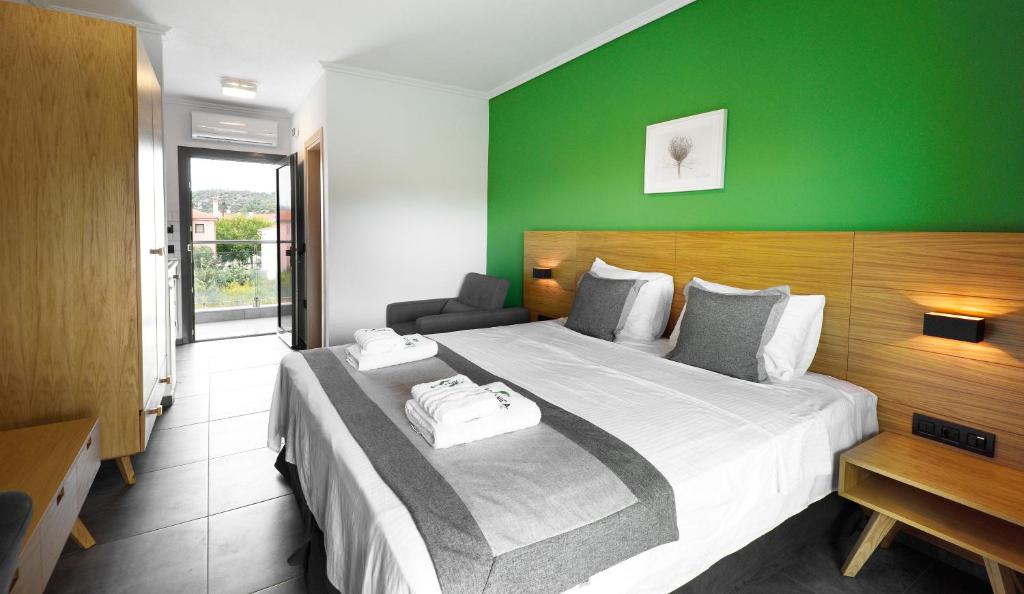 A bed or beds in a room at Botanica Luxury Suites