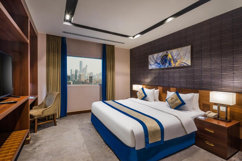 a hotel room with a bed and a television at Al Malqa Elite Hotel in Riyadh