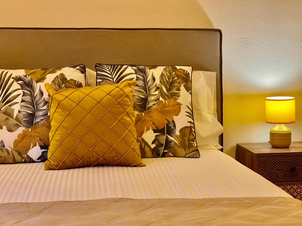 a bed with a yellow pillow on top of it at Iras in Samos