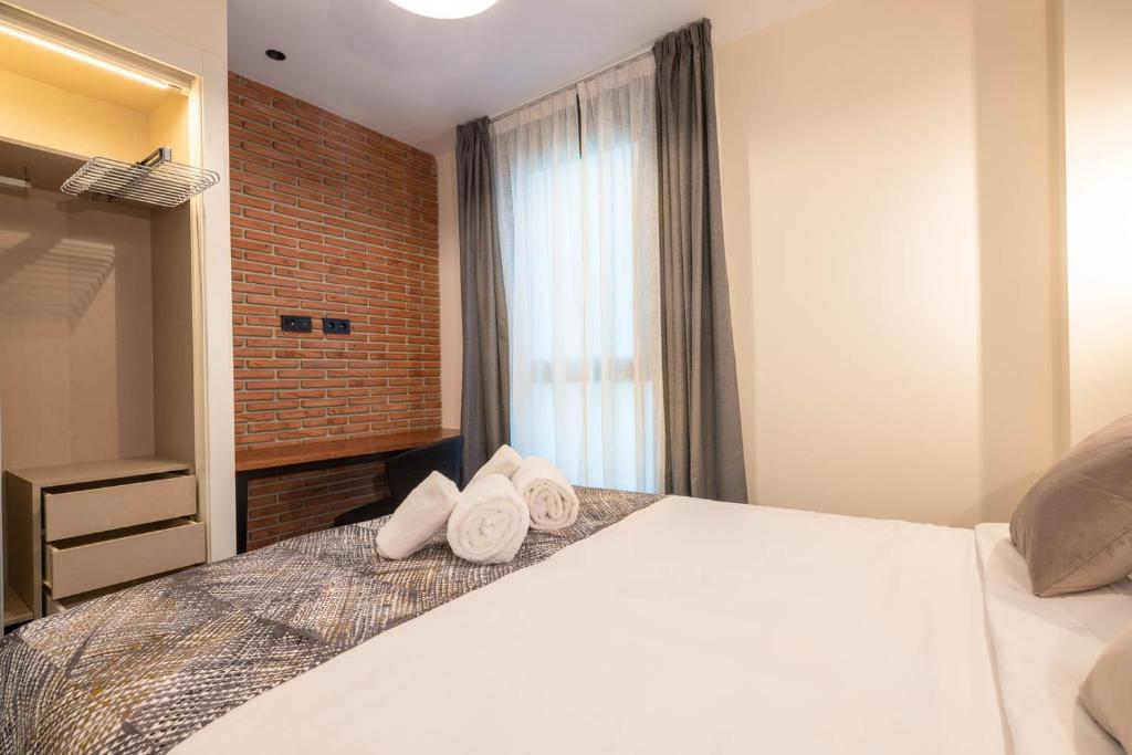 Posteľ alebo postele v izbe v ubytovaní Home Art Apartments Soho