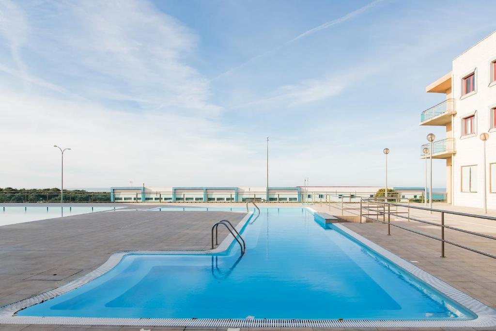 a swimming pool on the side of a building at Beach House Ericeira in Ericeira