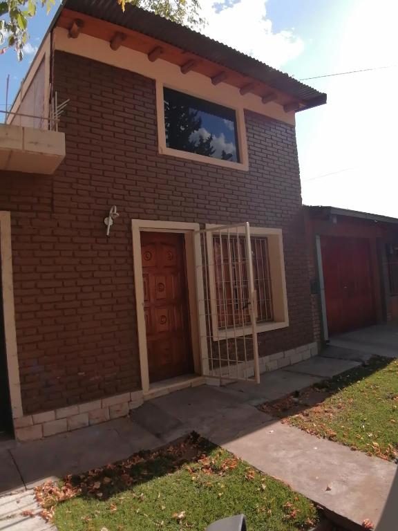 a house with a red brick at Departamento nazuc in San Rafael