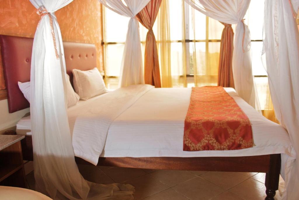 Postel nebo postele na pokoji v ubytování Pearl Palace Hotel