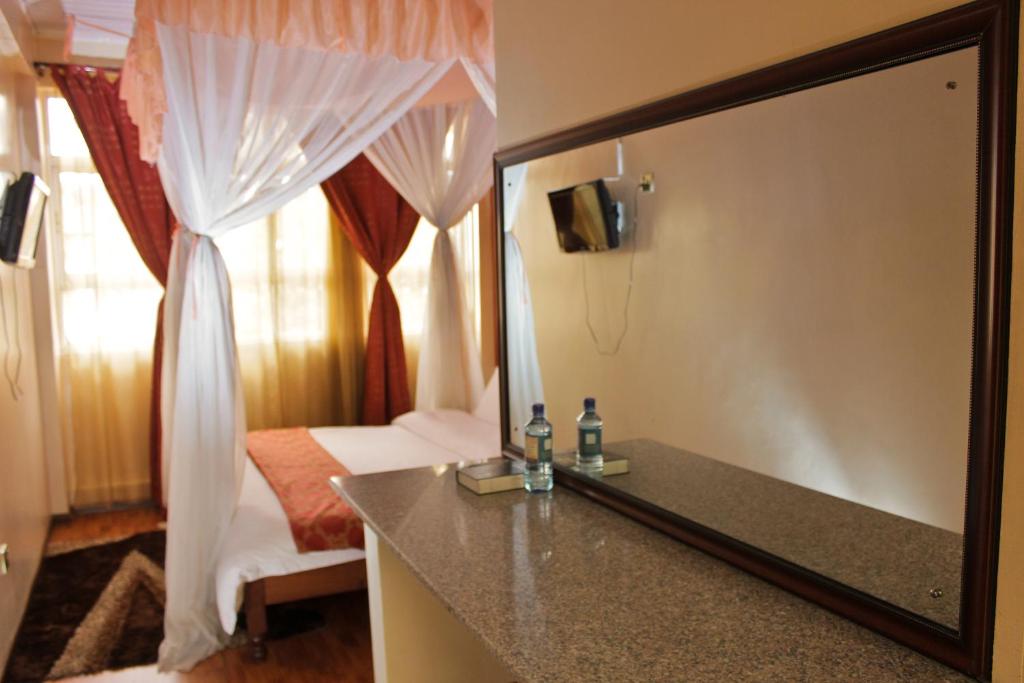 Postel nebo postele na pokoji v ubytování Pearl Palace Hotel