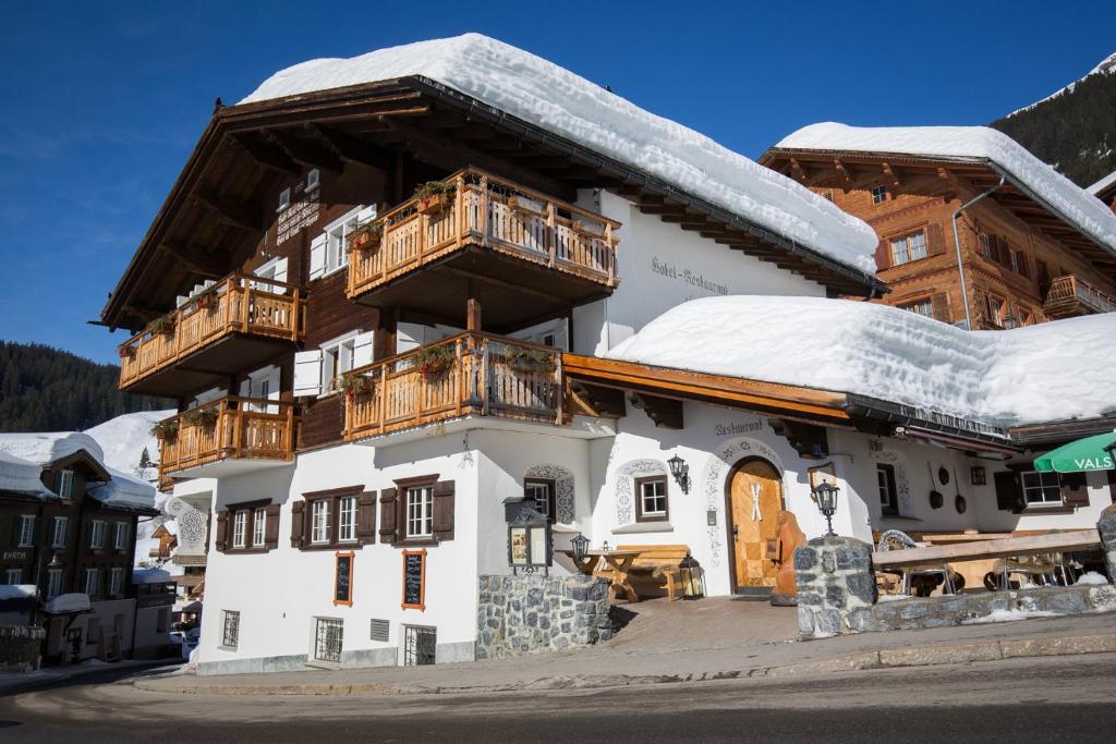 a large building with snow on the roof at Hotel Madrisajoch in Sankt Antönien