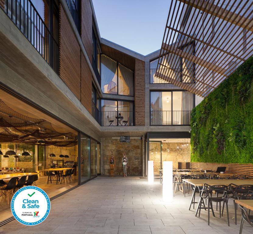 an internal view of a restaurant with tables and chairs at 7 Gaia Roaster Apartments in Vila Nova de Gaia