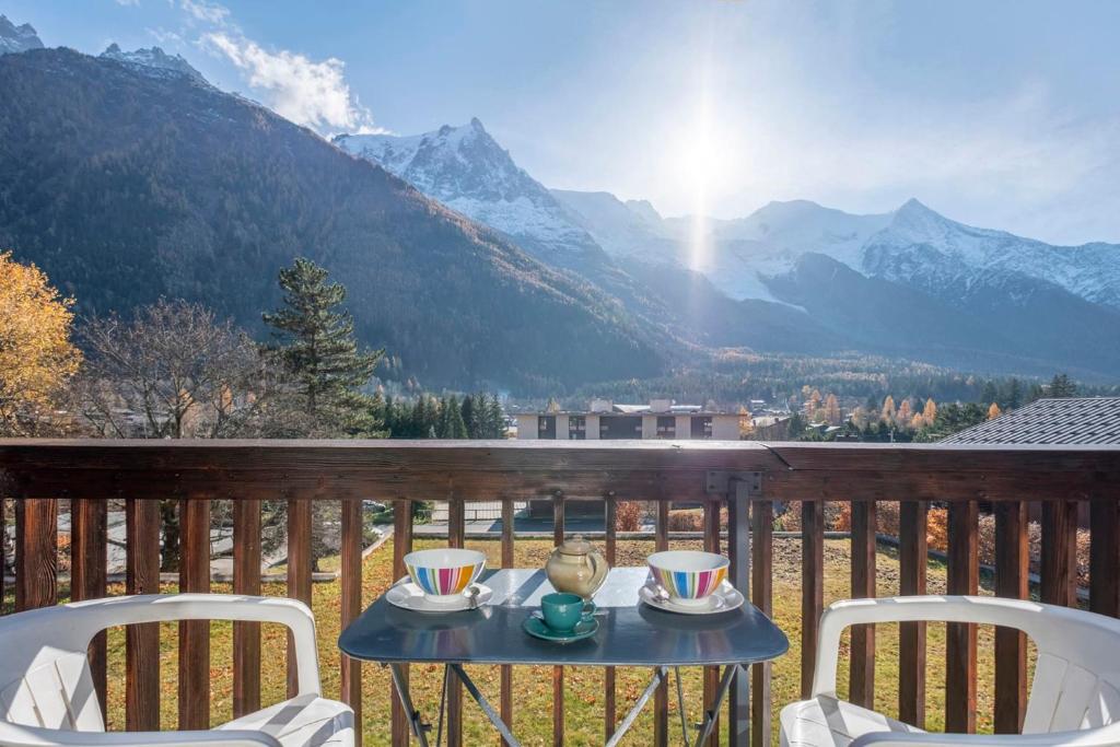 a table on a balcony with a view of mountains at Nice Studio With Balcony In Chamonix in Chamonix