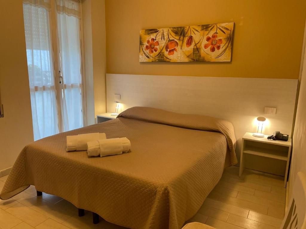 Giường trong phòng chung tại Hotel Ristorante Miramare